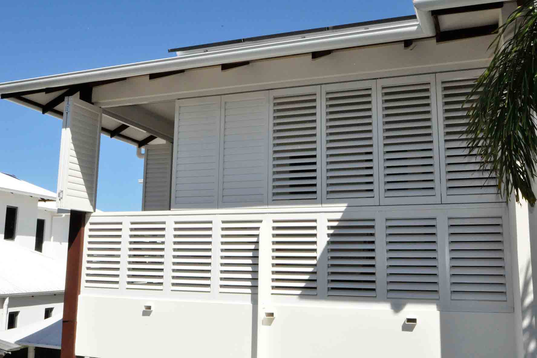 White aluminium shutters on the outside of a house