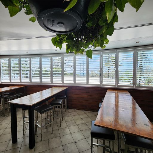With table and chair — Plantation Shutters Sunshine Coast in Moffat Beach, QLD